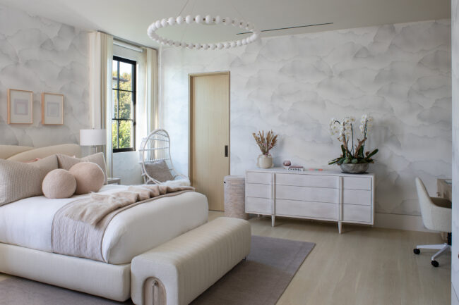 A bedroom with white walls and furniture in it