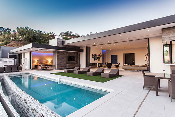 A modern home with a swimming pool and lounge area.