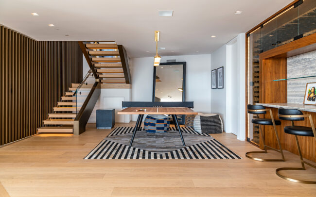 A living room with stairs and a table