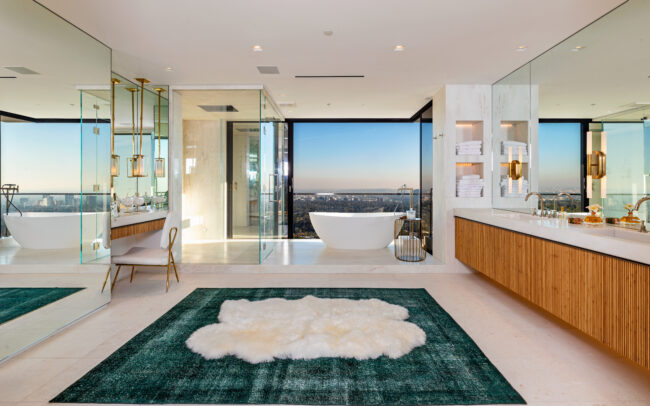 A bathroom with a large rug in the middle of it