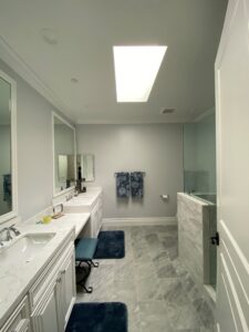 A bathroom with two sinks and a mirror.