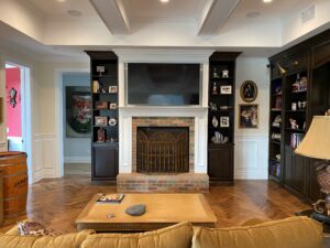 A living room with a fireplace and bookcases