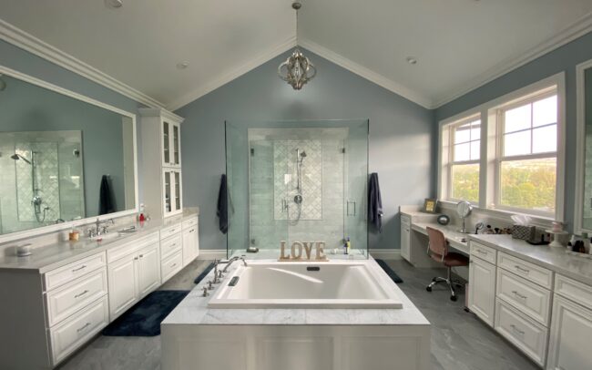 A large bathroom with a tub and sink.
