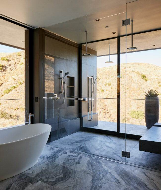 A bathroom with a tub, shower and window.