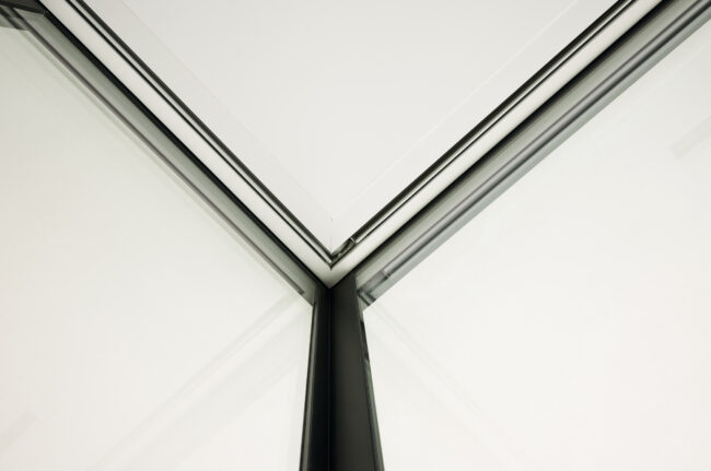 A corner of an open ceiling with two lines.