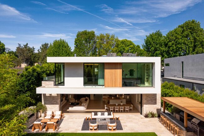 A modern house with patio furniture and outdoor seating.