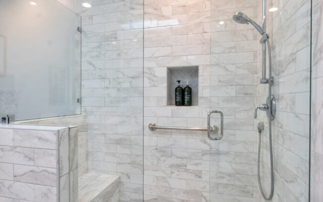 A bathroom with marble walls and floors.