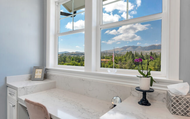 A bathroom with a view of the mountains.
